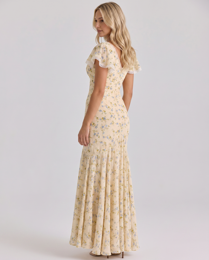 Female model wearing a lined floral maxi dress on a plain background.