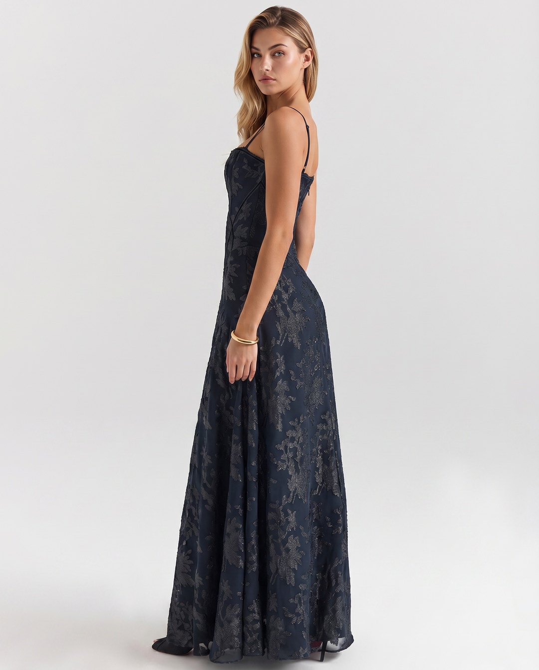 Model wearing a sleeveless navy dress with a flowing skirt on a plain background.