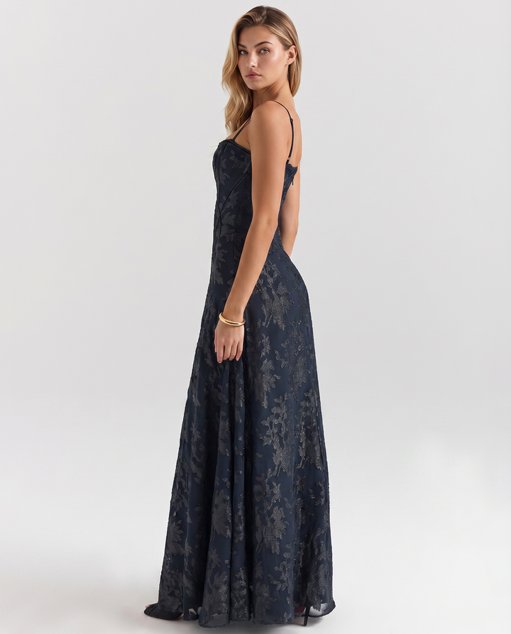 Model wearing a sleeveless navy dress with a flowing skirt on a plain background.