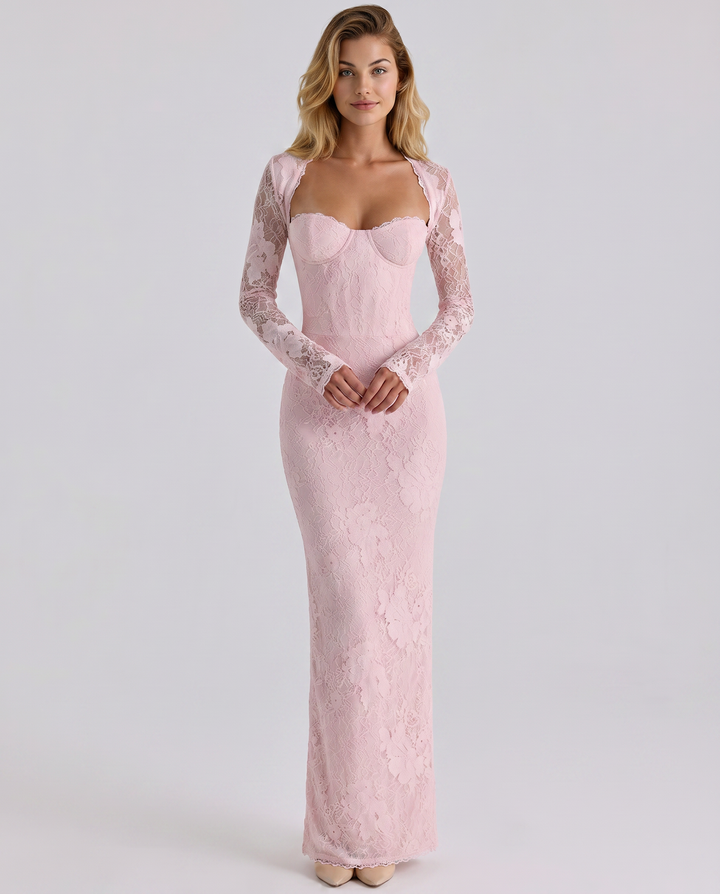 Female model wearing a fitted lace maxi dress with long sheer sleeves on a plain background.