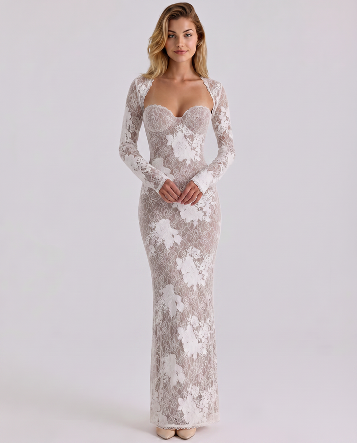 Female model showcasing a textured lace evening dress with a contoured shape on a plain background.