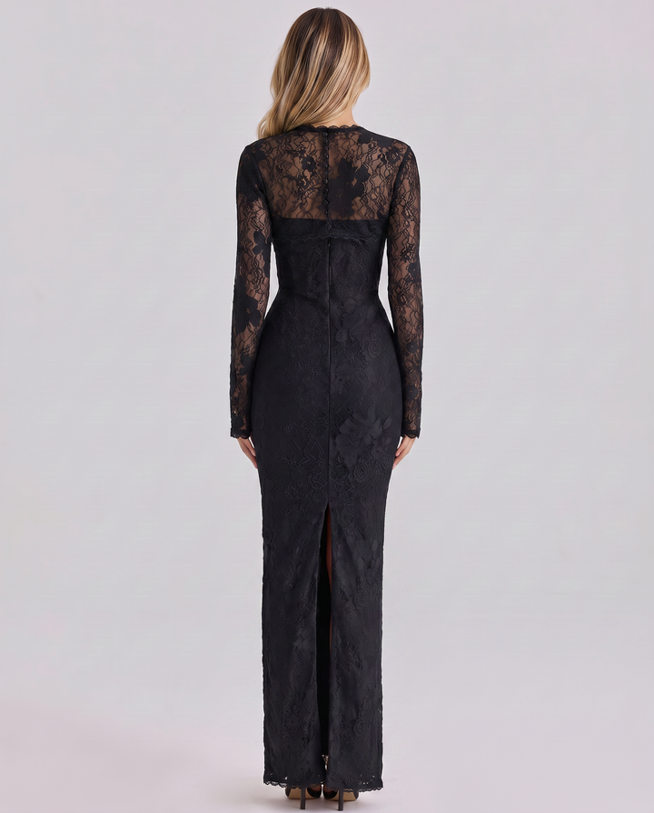 Woman in a long sleeve lace maxi dress with a smooth lined finish on a plain background.