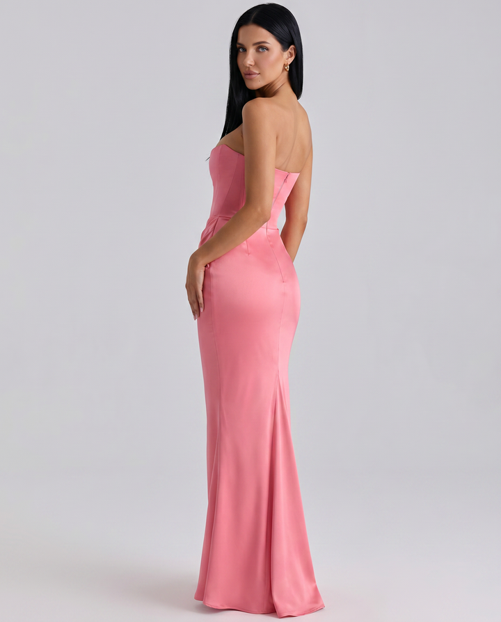 Female model showcasing a strapless corset-style dress with soft waist draping.
