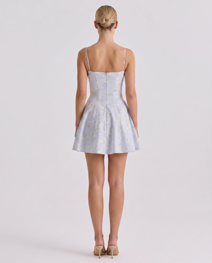 Woman modeling a lightweight sleeveless dress with a clean neckline on a plain background.