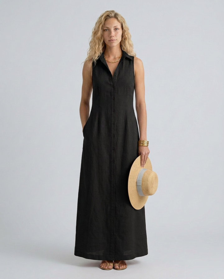 Woman wearing a flowing sleeveless shirt dress with side pockets on a plain background.
