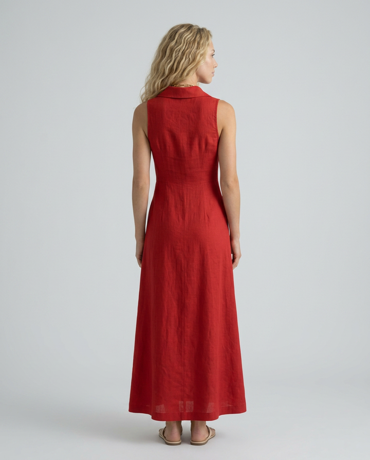  Woman wearing a versatile sleeveless dress with a tailored shape on a plain background.