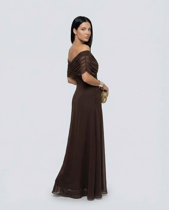 Female model wearing a graceful dress for special occasions on a plain background.