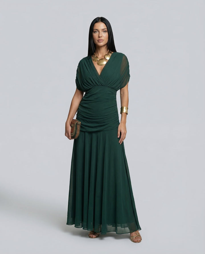 Woman wearing a refined celebration dress with gentle shaping on a plain background