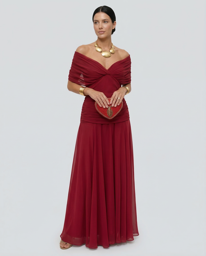 Female model wearing an event-ready dress with soft movement on a plain background.