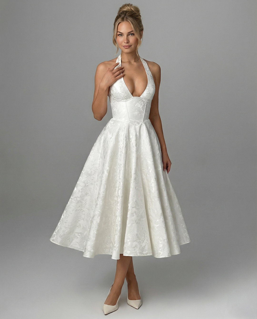 Female in a woven textured midi dress styled with a flared skirt silhouette.