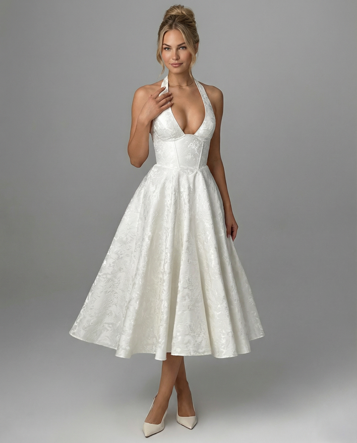 Female in a woven textured midi dress styled with a flared skirt silhouette.