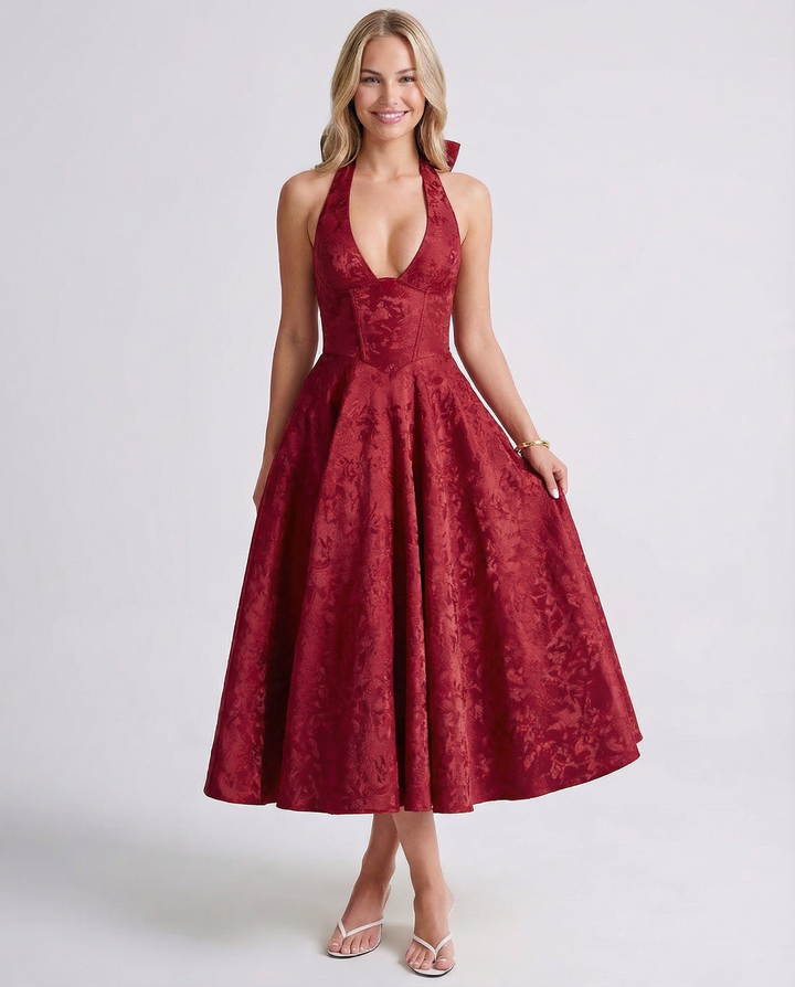 Female model showcasing a sleeveless jacquard midi dress with a voluminous skirt.