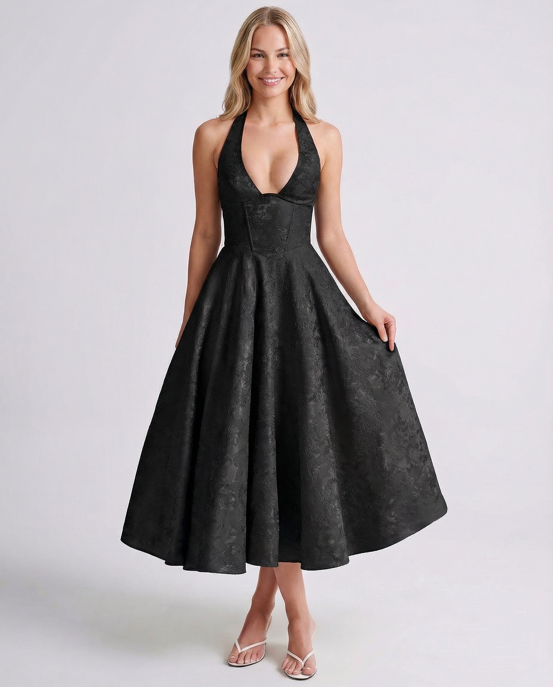 Female wearing a flared midi dress with a fitted waist and textured woven finish.