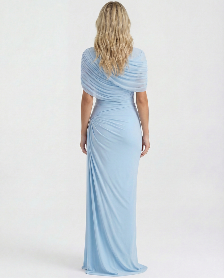 Woman styled in a high neckline maxi dress against a plain background.