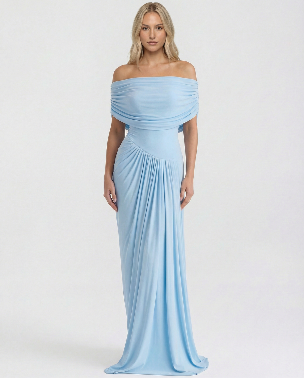 Female model in a ruched waist evening dress on a plain background.
