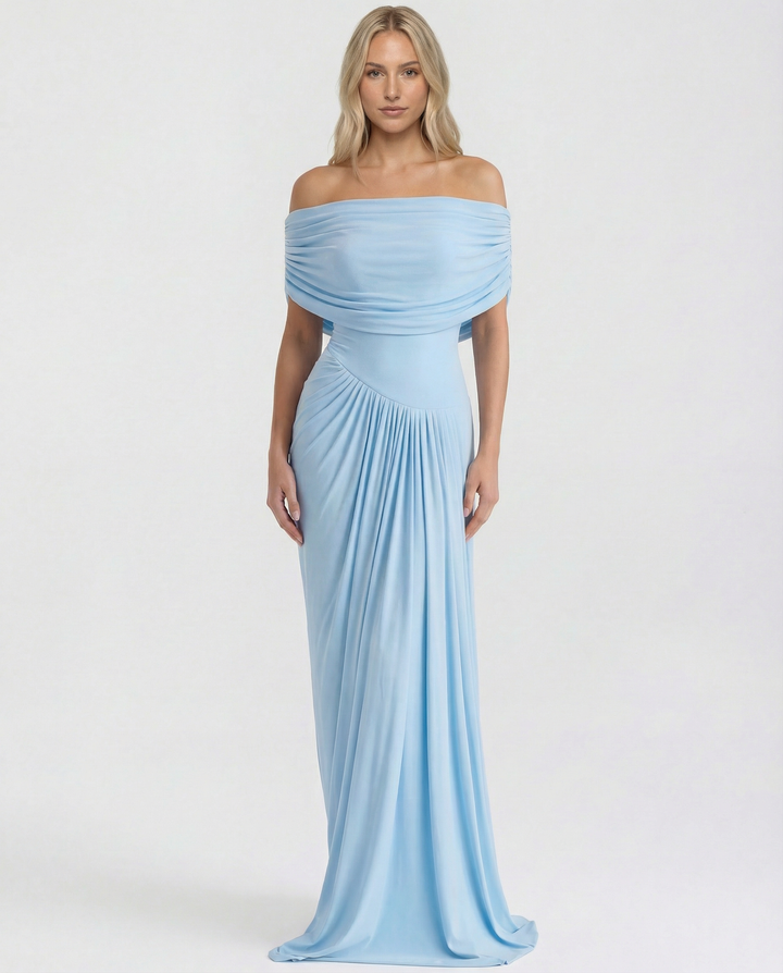 Female model in a ruched waist evening dress on a plain background.