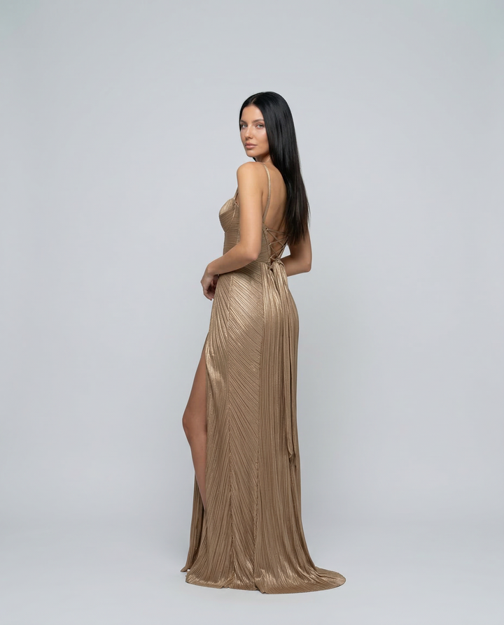 Woman wearing a sweetheart neckline maxi dress with a side slit on a plain background.