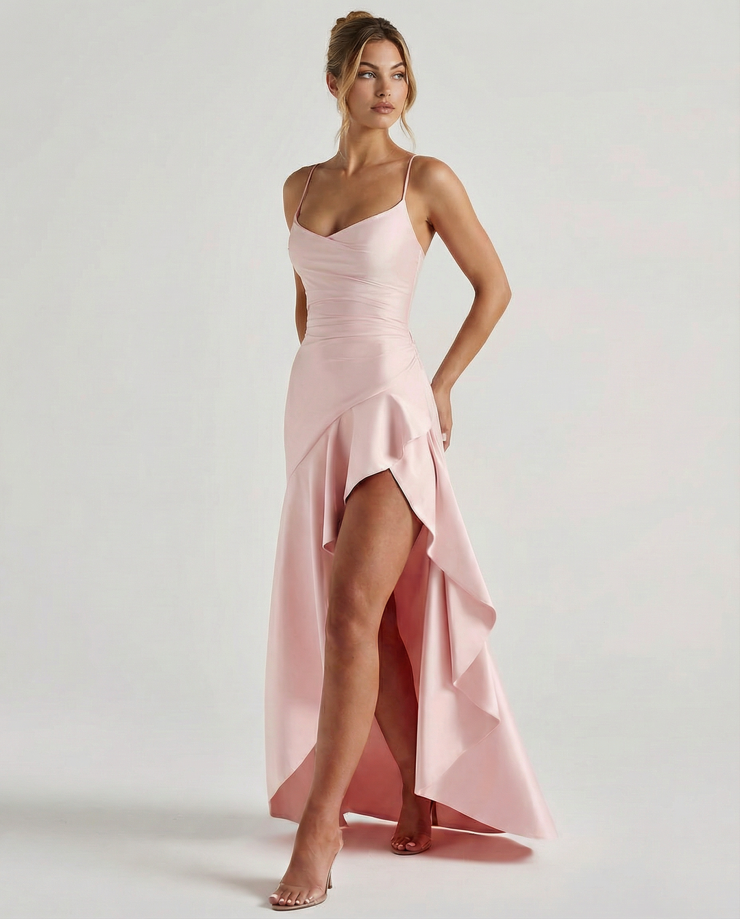 Female model wearing a satin-look maxi dress with slim straps on a plain background.