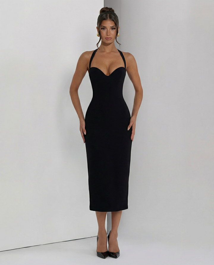 Woman in an elegant midi dress with a flowing hemline and soft neckline.