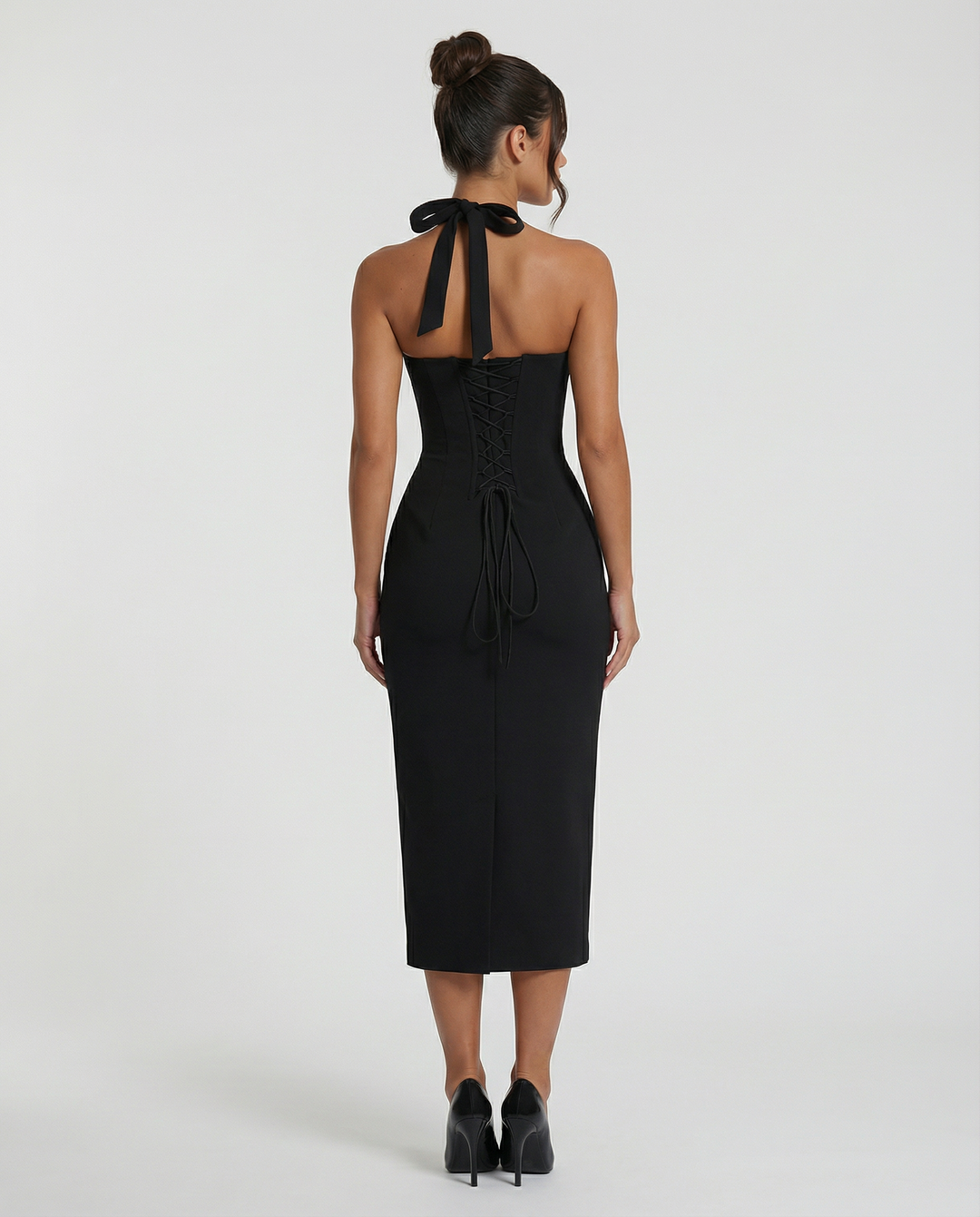 Female posing in a sophisticated off-shoulder dress on a plain background.