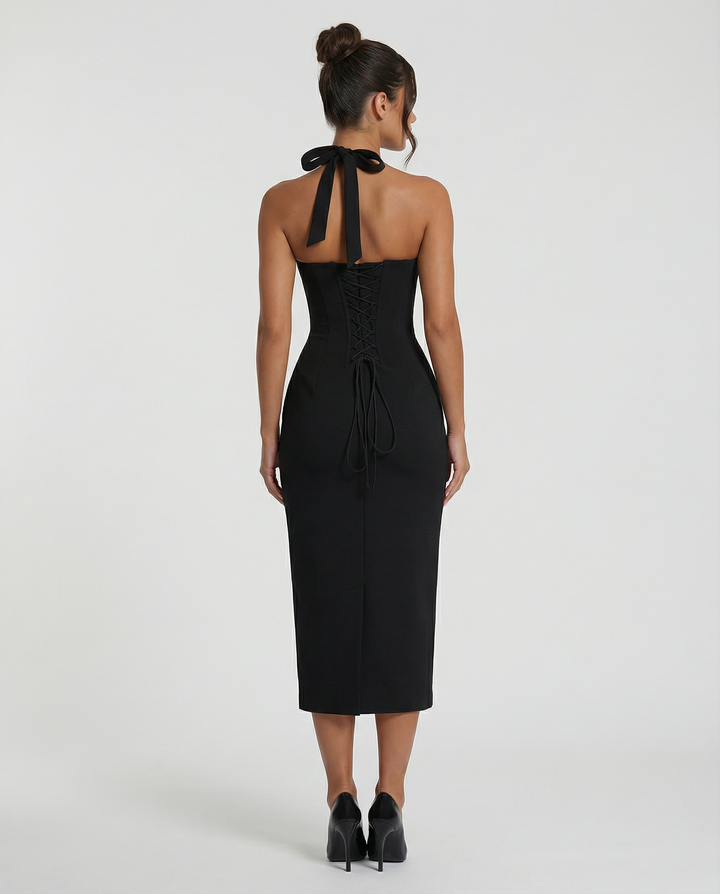Female posing in a sophisticated off-shoulder dress on a plain background.
