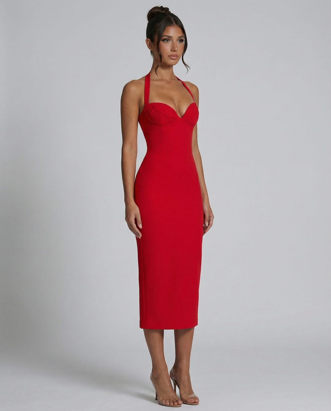 Female in a stylish off-shoulder midi dress photographed on a plain background.