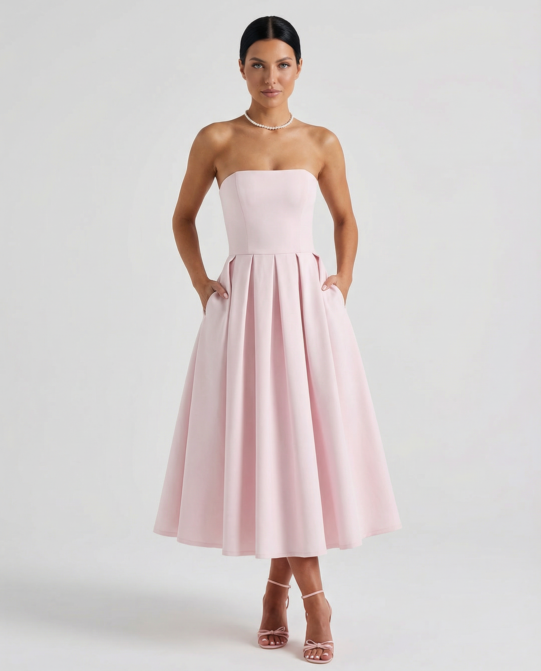 Female model wearing a polished event dress on a plain background.