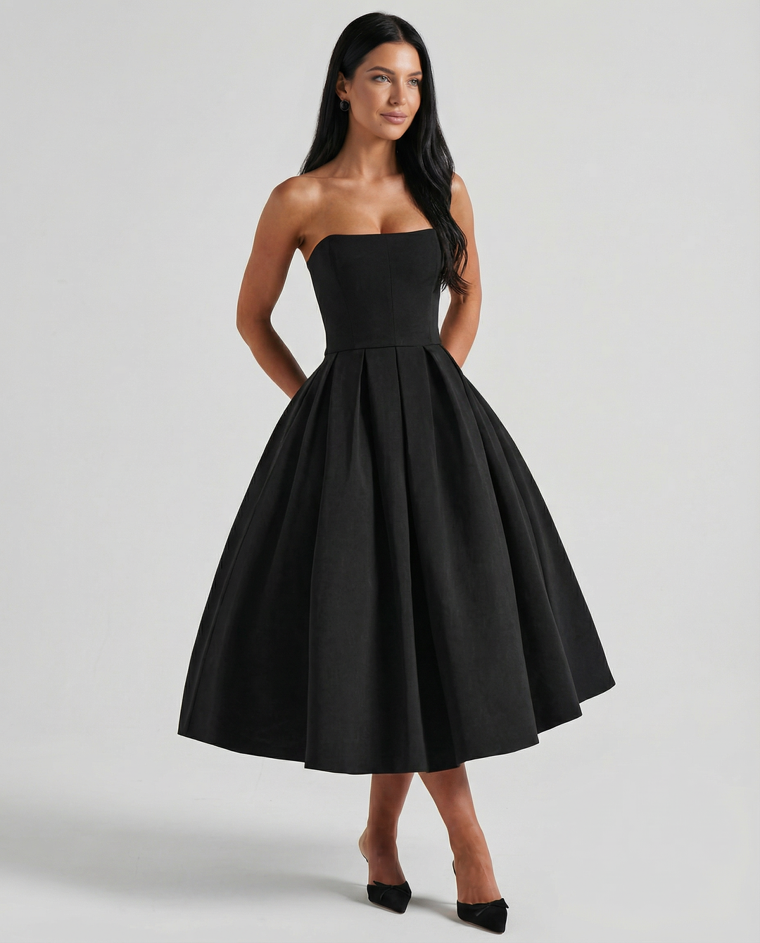 Model wearing a graceful formal dress with a defined waist on a plain background.