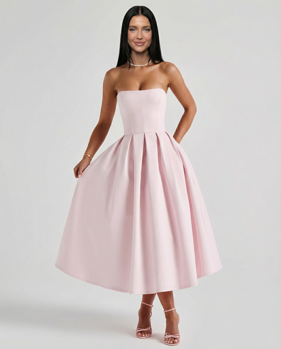 Female model in a refined evening dress against a plain background.