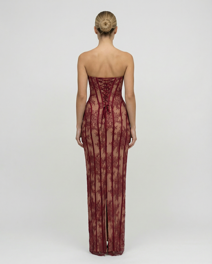 Female in a fitted full-length lace overlay dress with sweetheart neckline on a plain background.