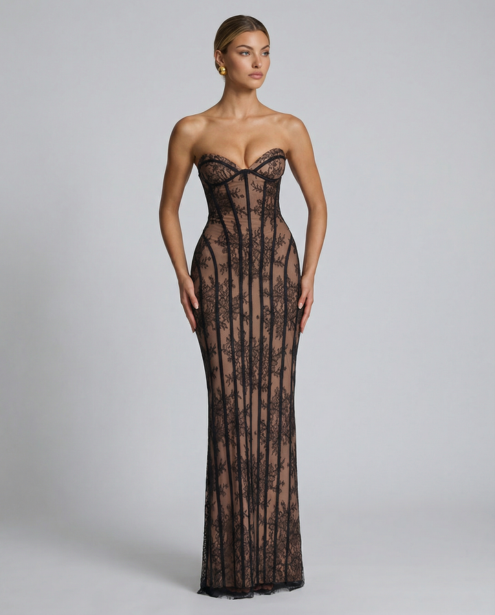 Woman wearing a full-length fitted dress with back split on a plain background.