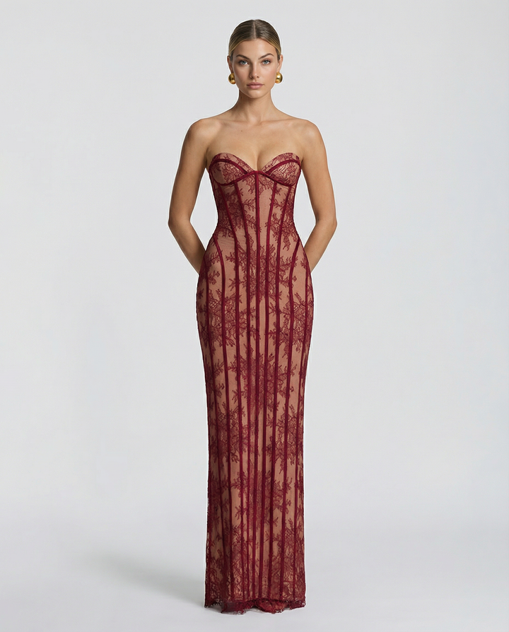 Woman wearing a red strapless maxi dress with lace bodice on a plain background.