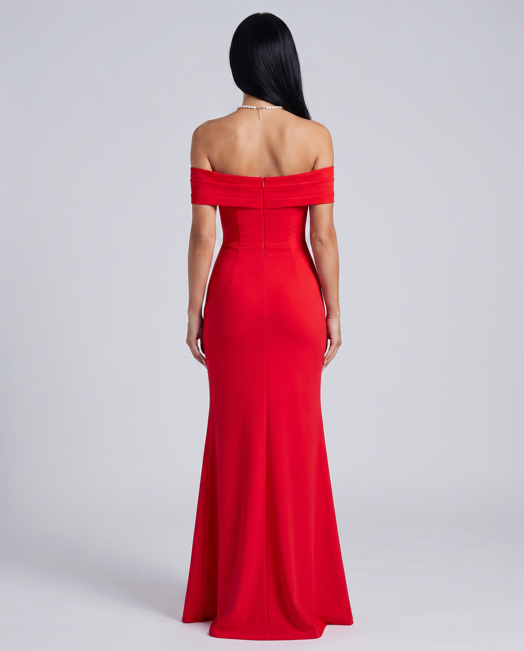 Woman in a structured waist maxi dress with plain background.