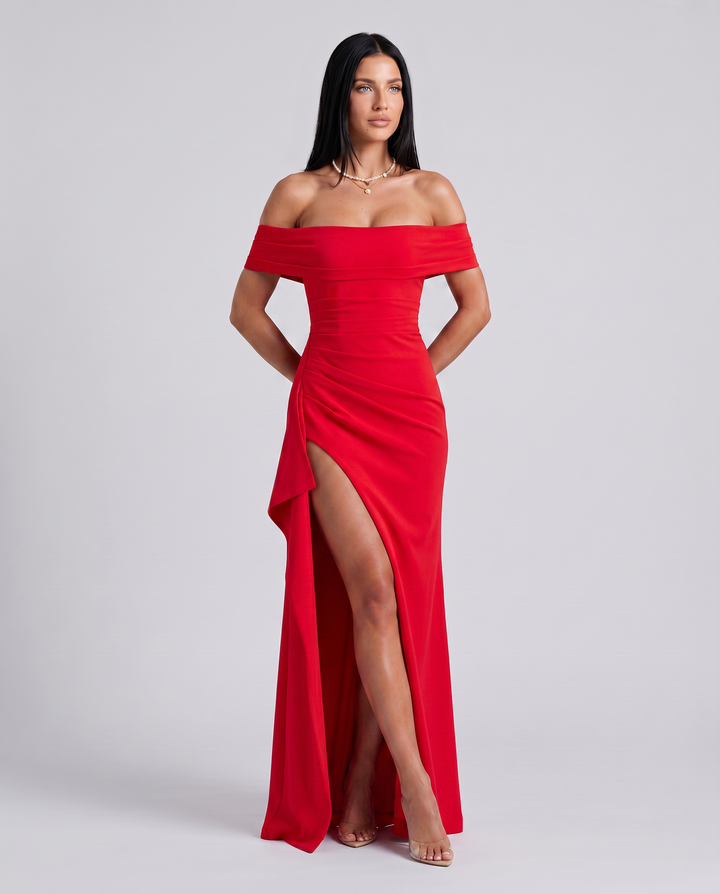 Female model styled in an off shoulder sleeveless dress on a plain background.