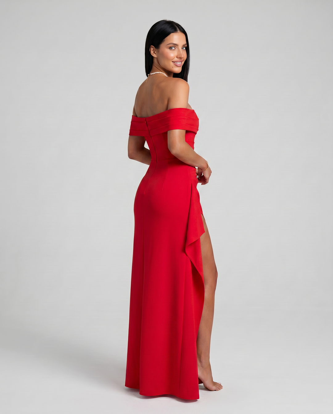 Female model wearing a sleek bodycon dress with side slit on a plain background.