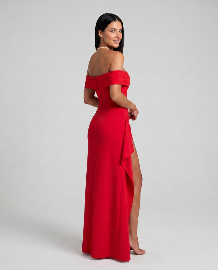 Female model wearing a sleek bodycon dress with side slit on a plain background.