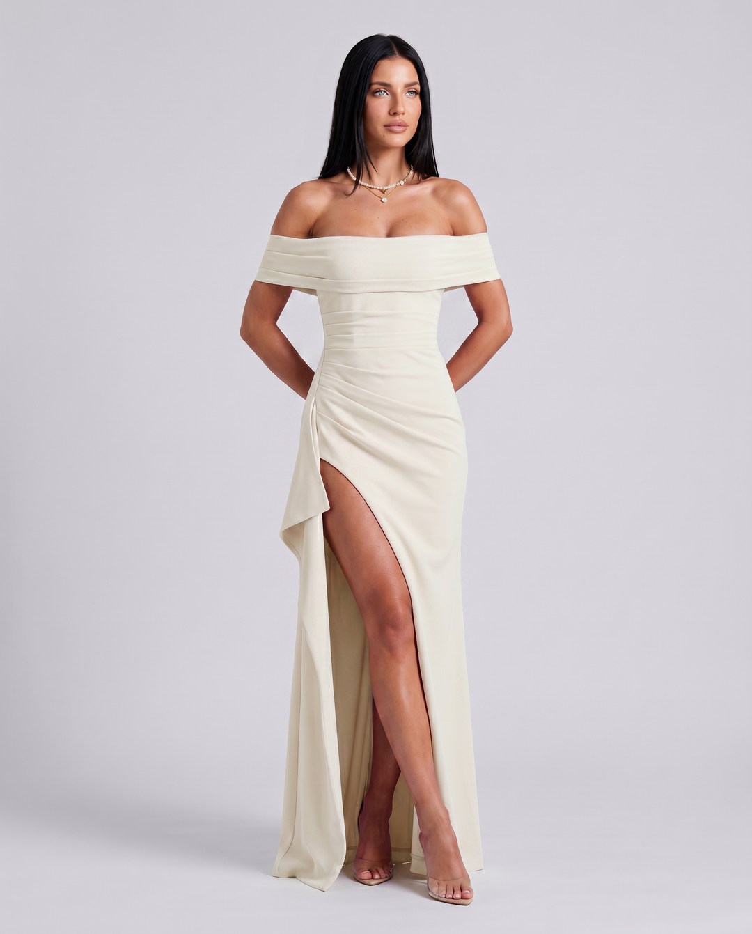 Female model in a sleeveless maxi dress with clean plain background.