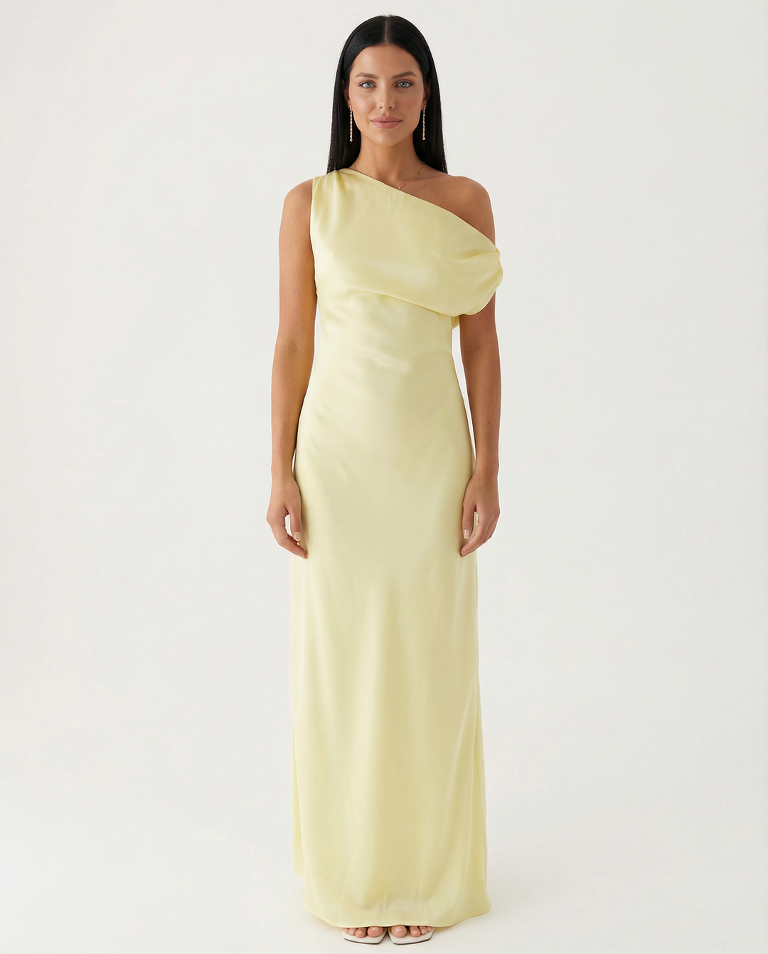 Woman wearing a fitted waist satin maxi dress on a plain background.