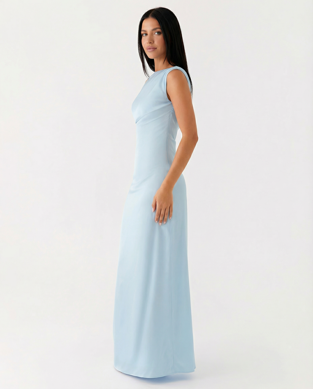 Female model wearing a draped bodice dress on a plain background.