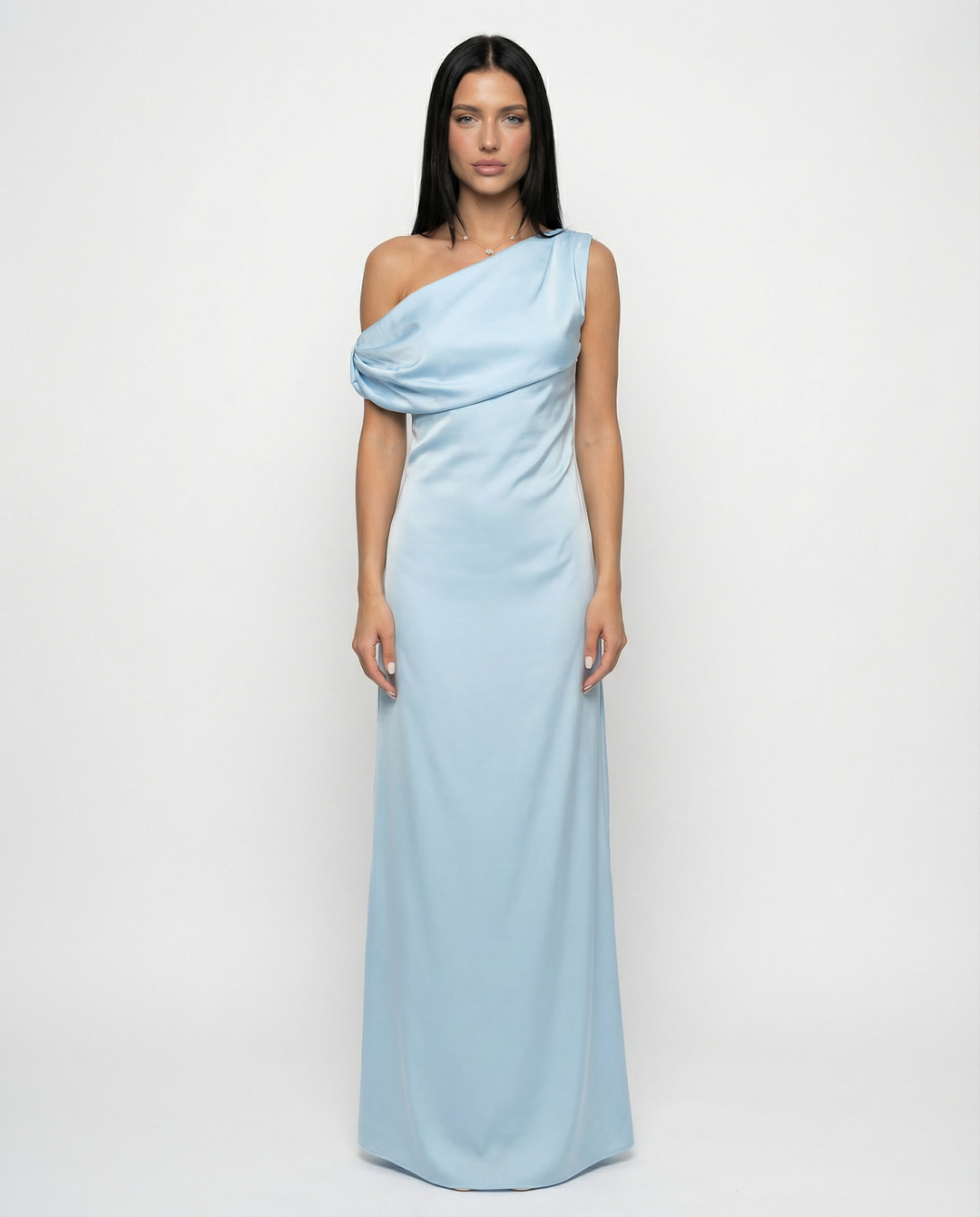Woman in a satin texture maxi dress with clean lines on a plain background.
