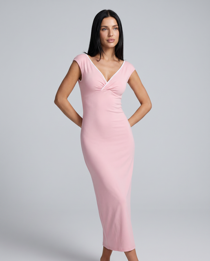 Female model wearing a pink evening maxi dress with fitted bodice on a plain background.