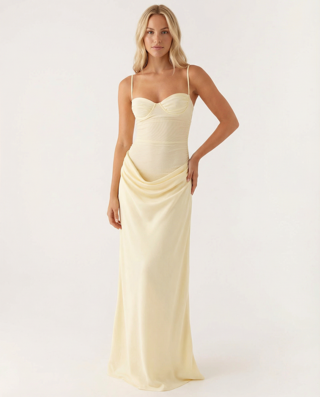 Female model wearing a yellow sweetheart neckline dress with adjustable straps on a plain background.