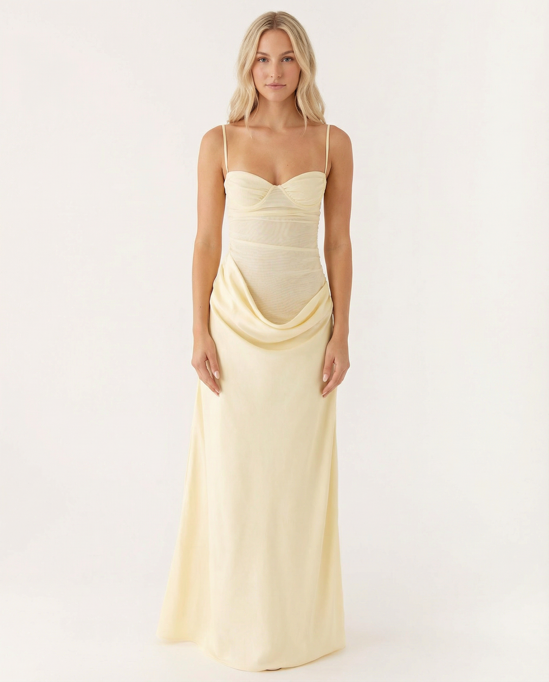 Female model in a pink long dress with fitted bodice and relaxed skirt on a plain background.