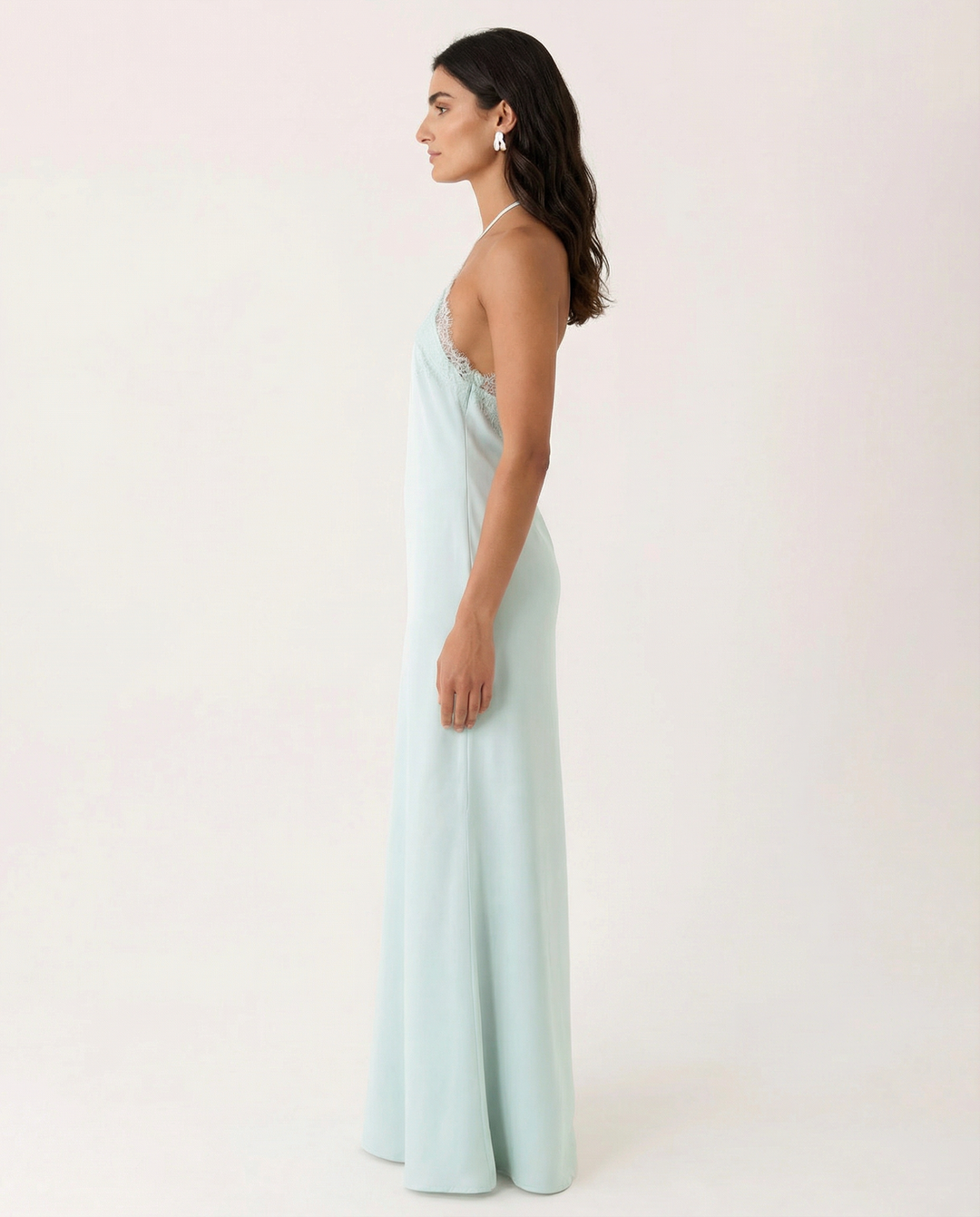 Model wearing a chocolate halter maxi dress with open back detail on a plain background.