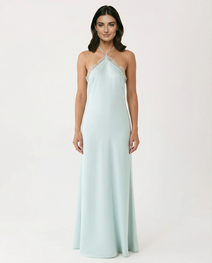 Female model wearing a blue halter neck maxi dress on a plain background.