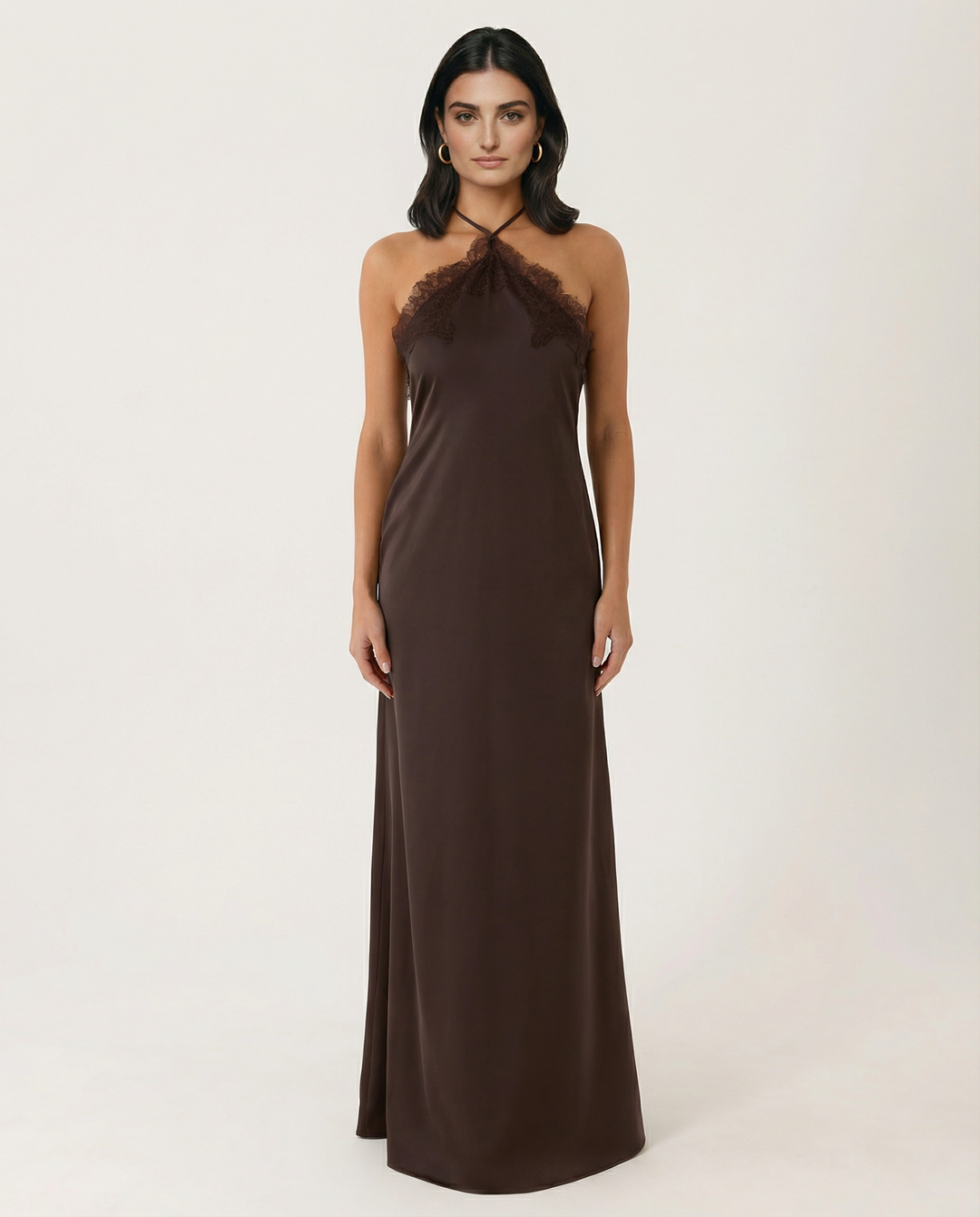 Woman wearing a sleeveless chocolate maxi dress with relaxed fit on a plain background.