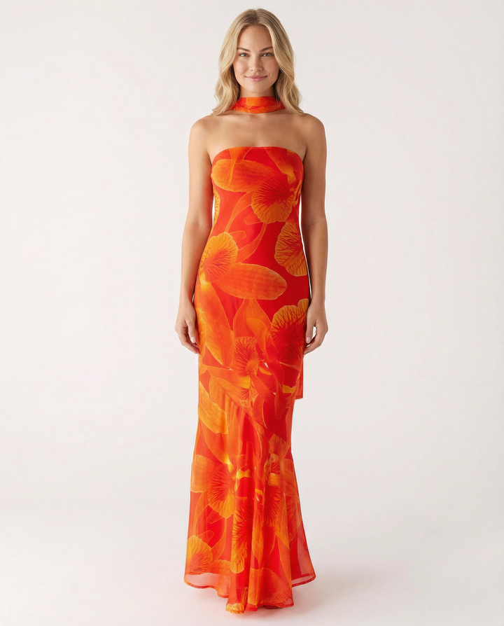 Woman dressed in a strapless long dress with a light, airy skirt.