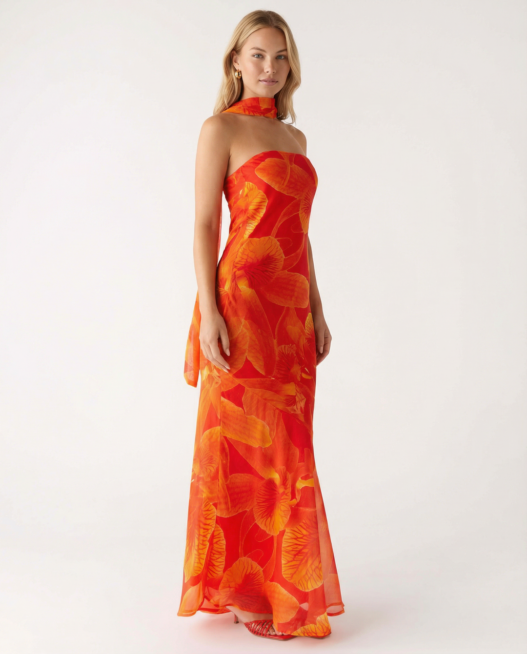 Female model showcasing a floral maxi dress with a scarf detail.