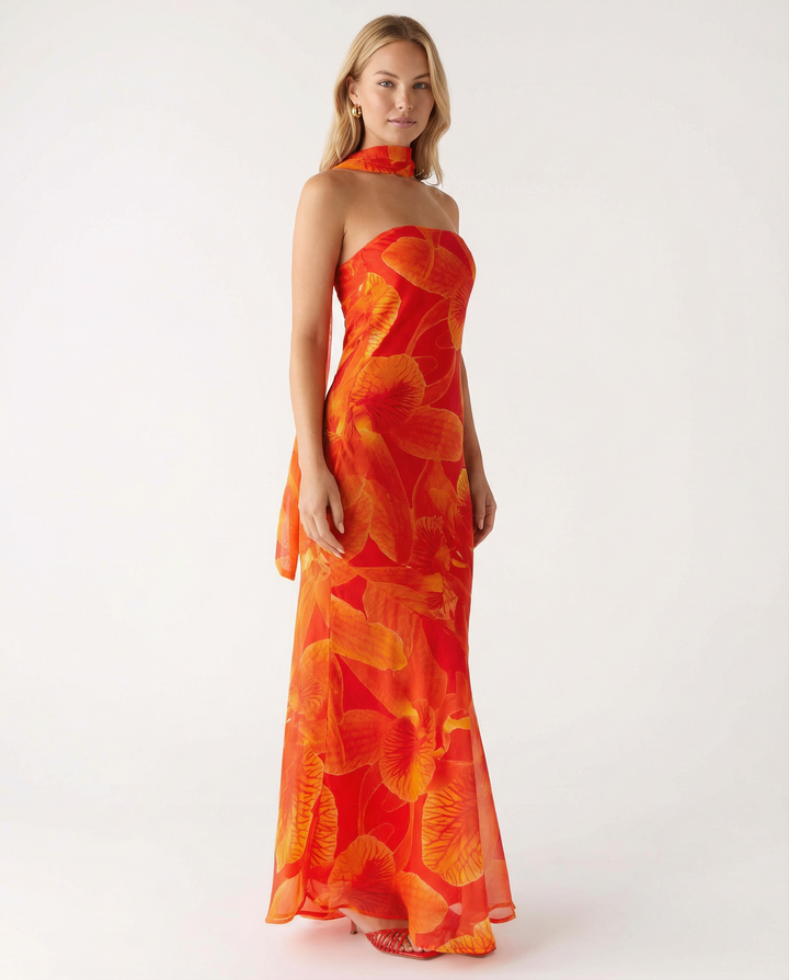 Female model showcasing a floral maxi dress with a scarf detail.