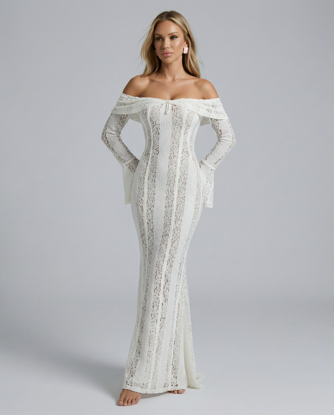 Female model wearing a white off shoulder lace maxi dress on a plain background.